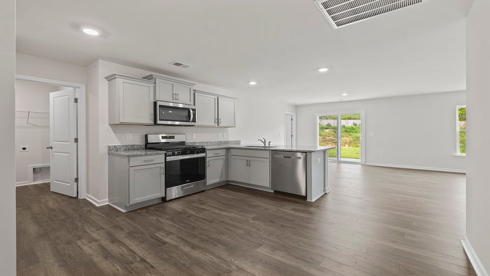 Kitchen with granite counteretops and stainless steel appliances.