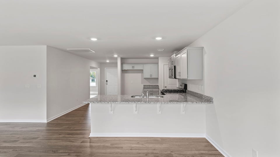 Kitchen with granite counteretops and stainless steel appliances.