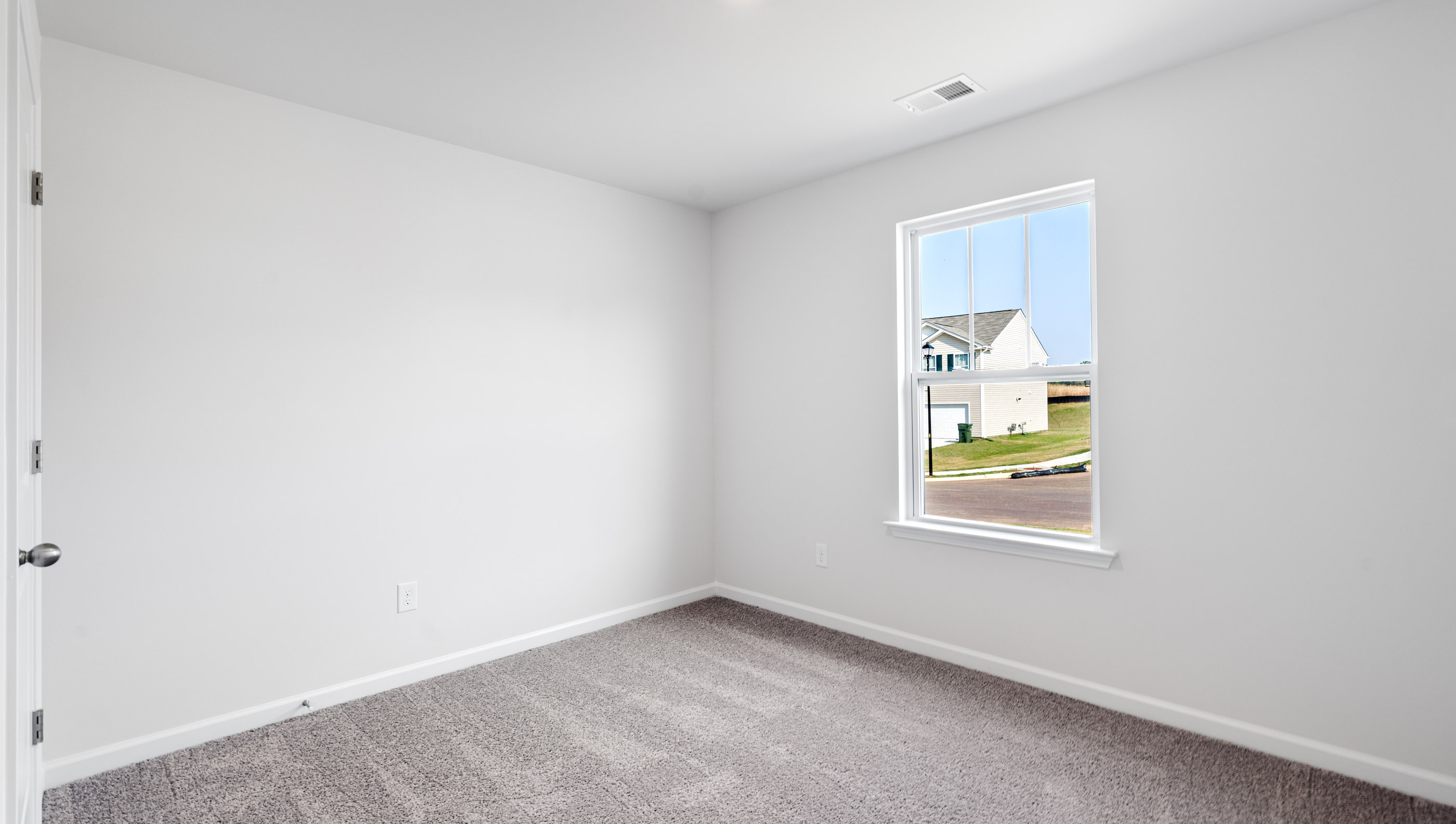 Bedroom with carpet and window.