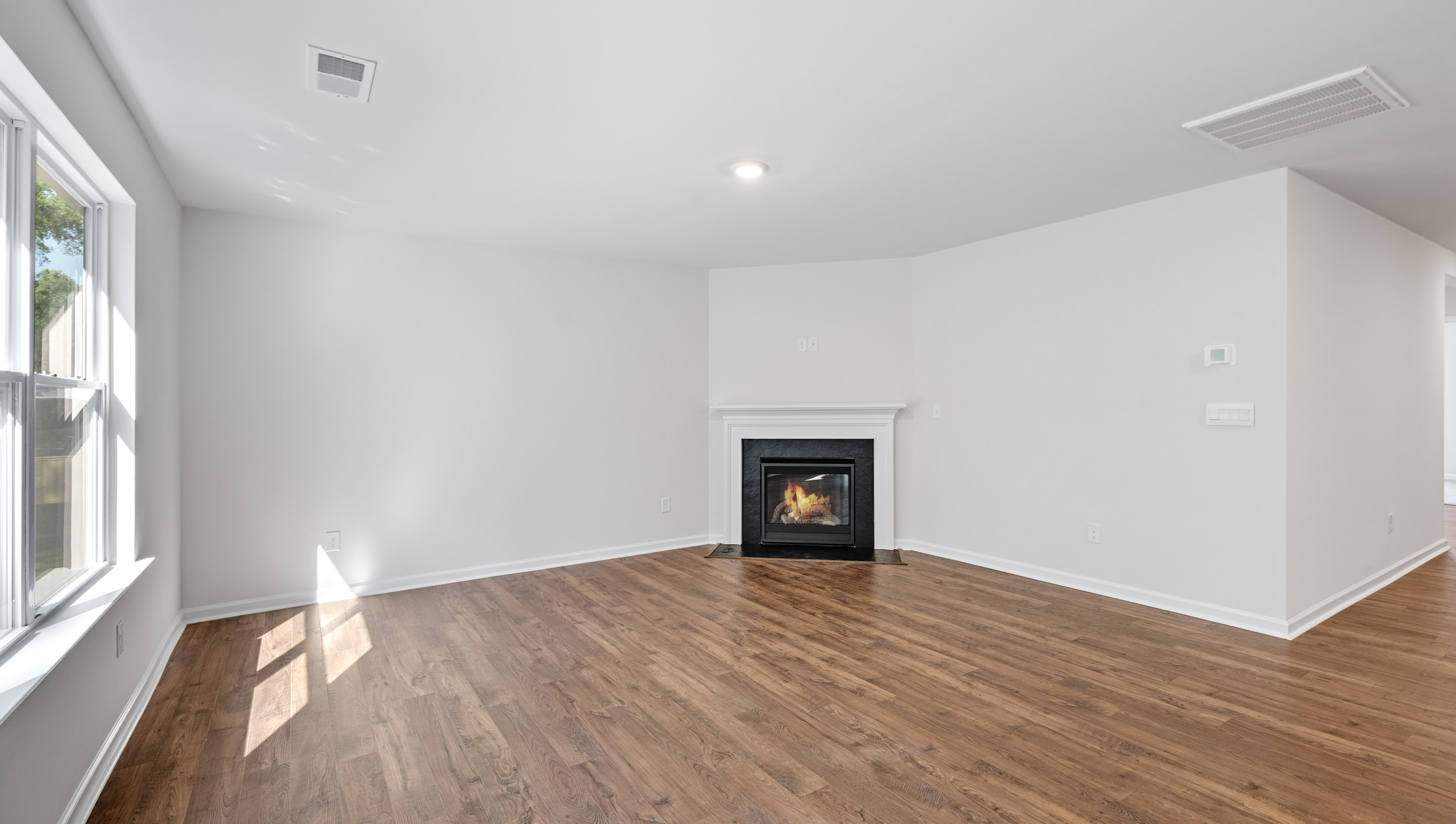 Family room with fireplace and windows.