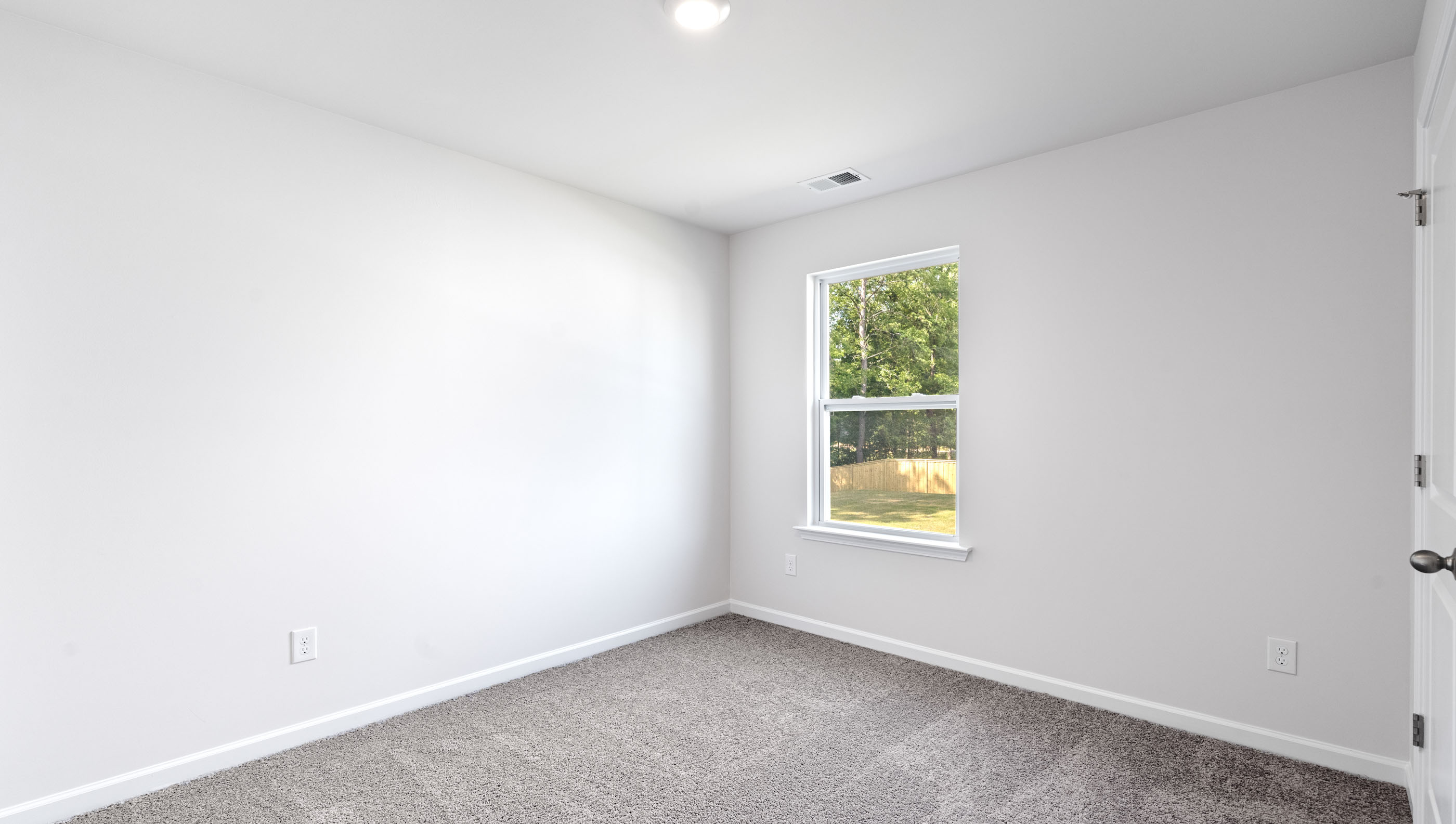 Bedroom with carpet and window.