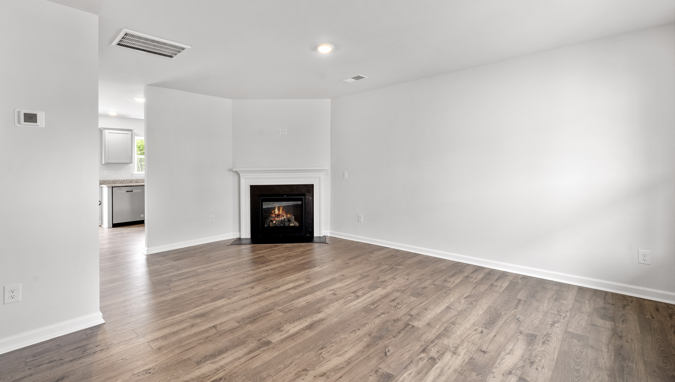 Family room with fireplace and windows.
