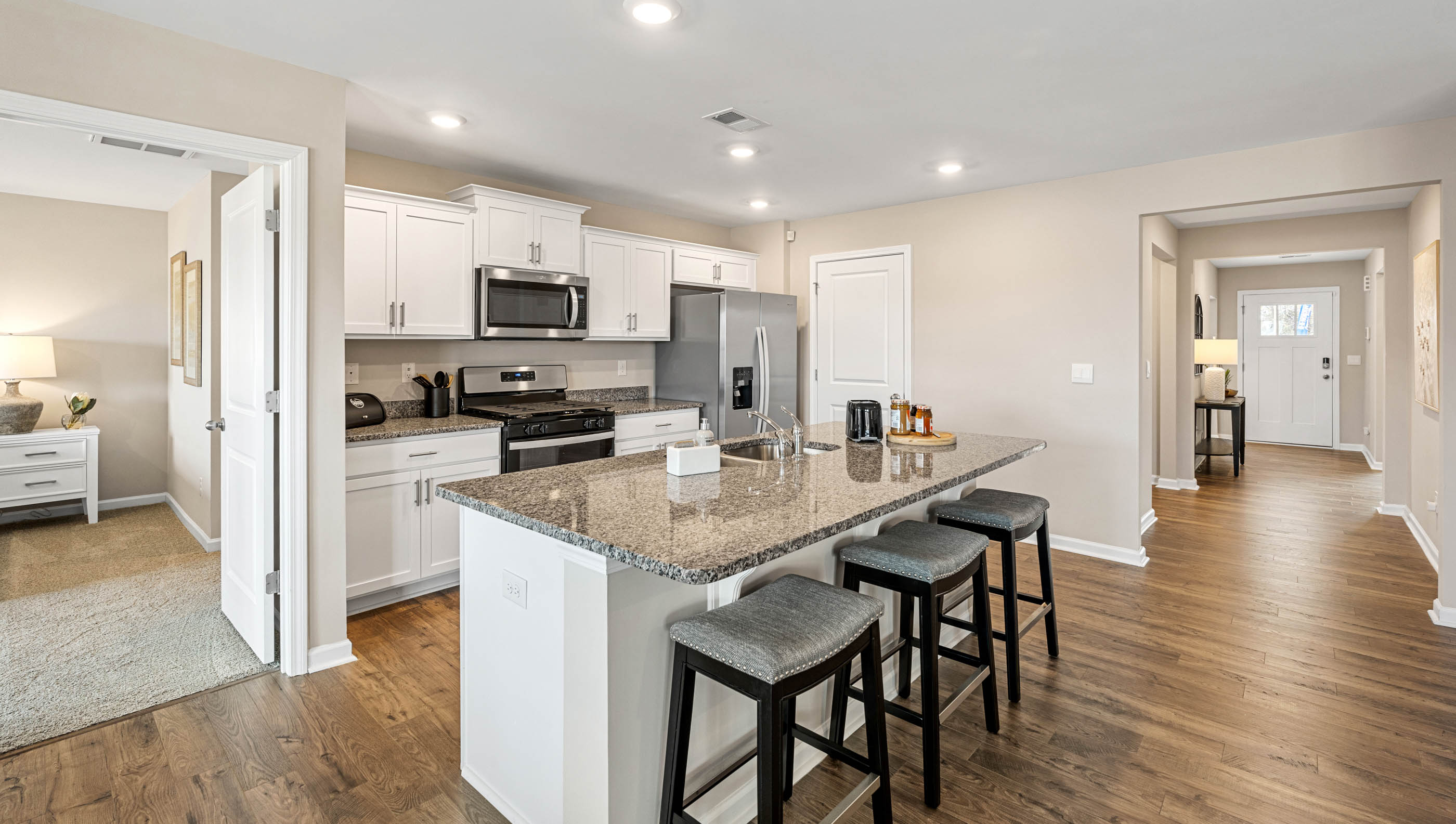 Kitchen and island with quartz countertops and stainless steel appliances.
