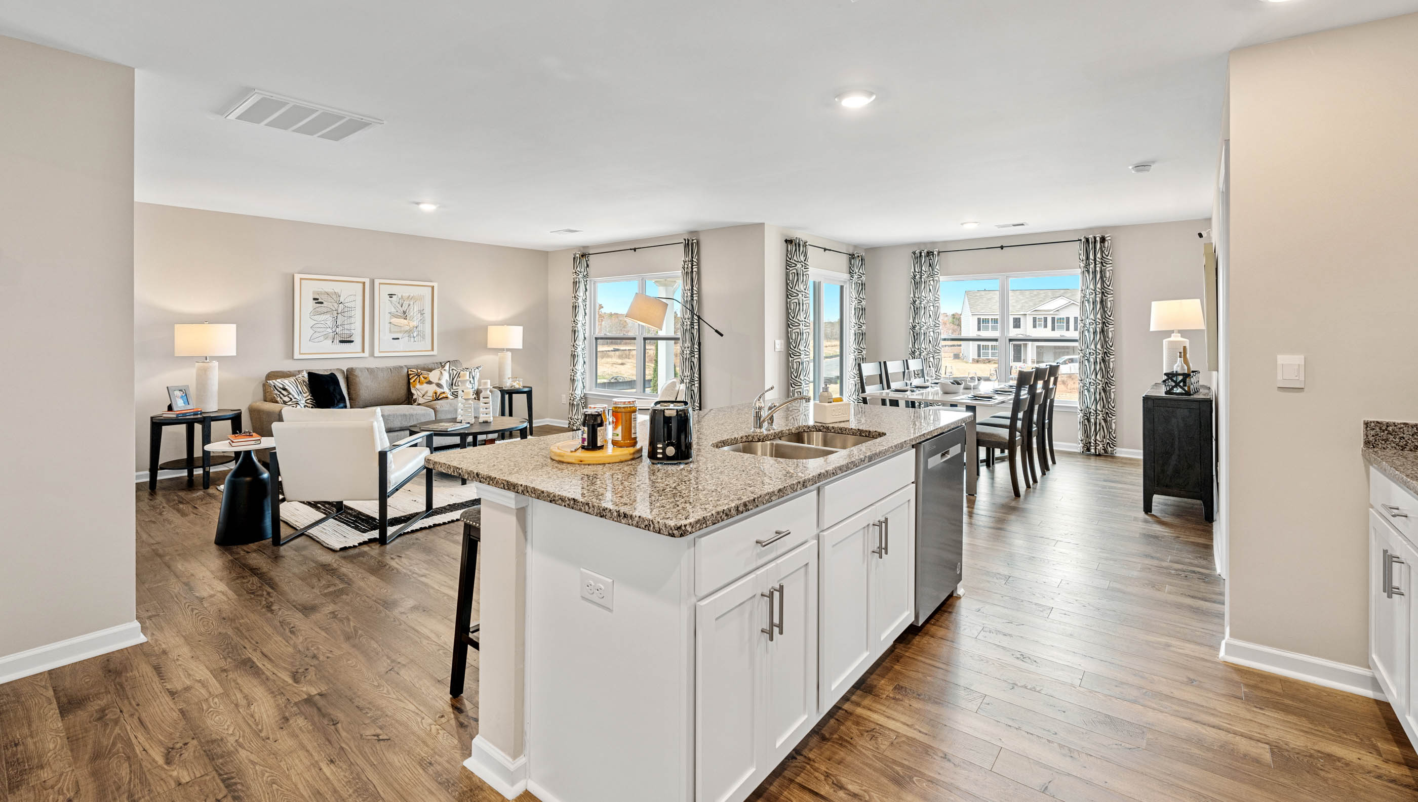 Kitchen and island with quartz countertops and stainless steel appliances.