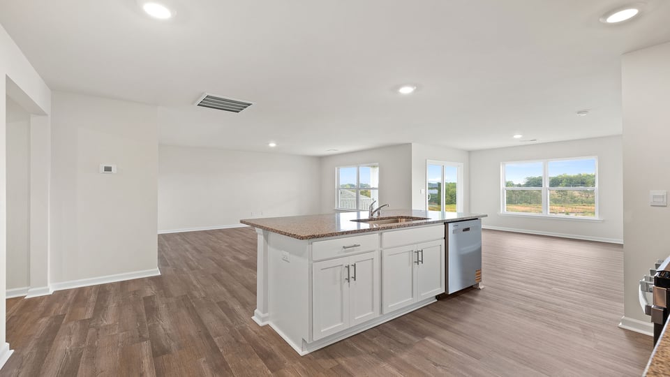Kitchen with island and granite countertops.
