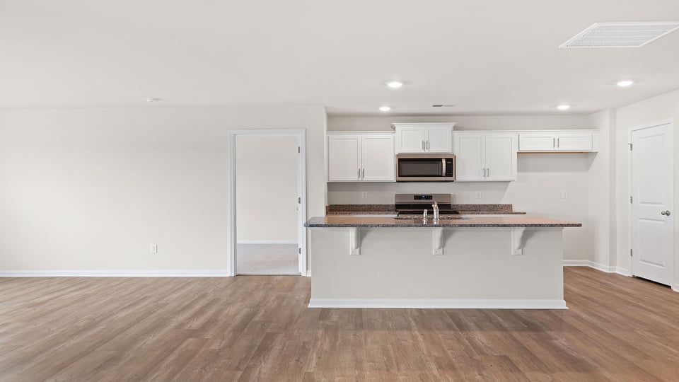 Kitchen with island and granite countertops.