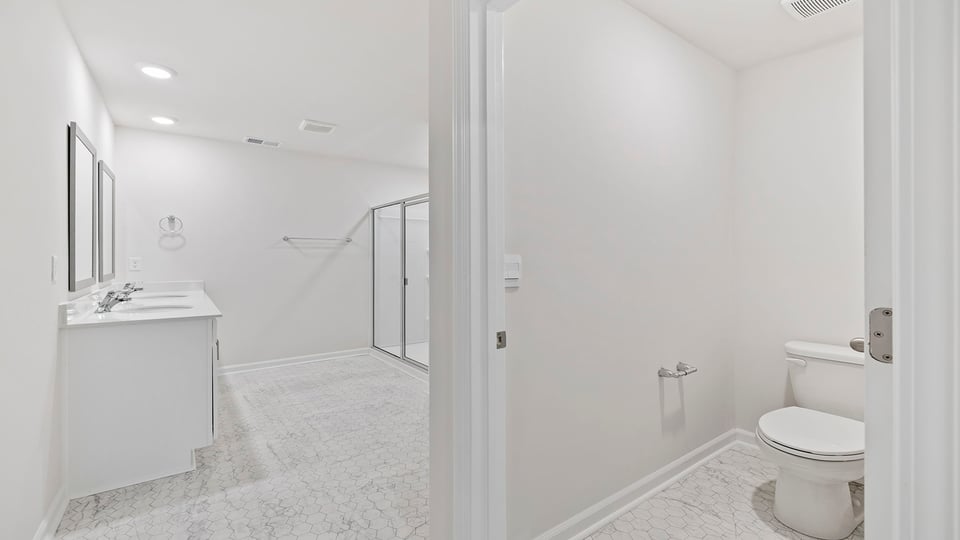 Bathroom with vanity and walk in shower.