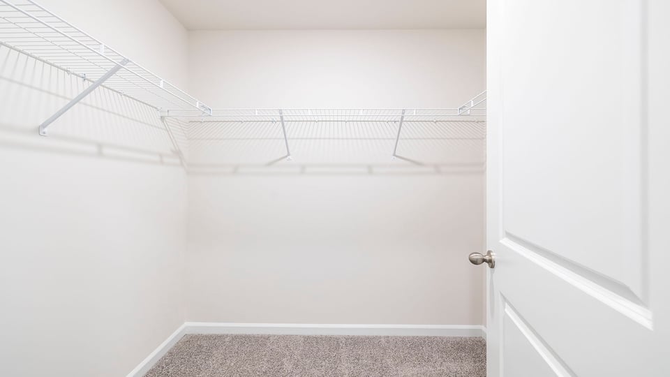 Walk in closet with shelves.