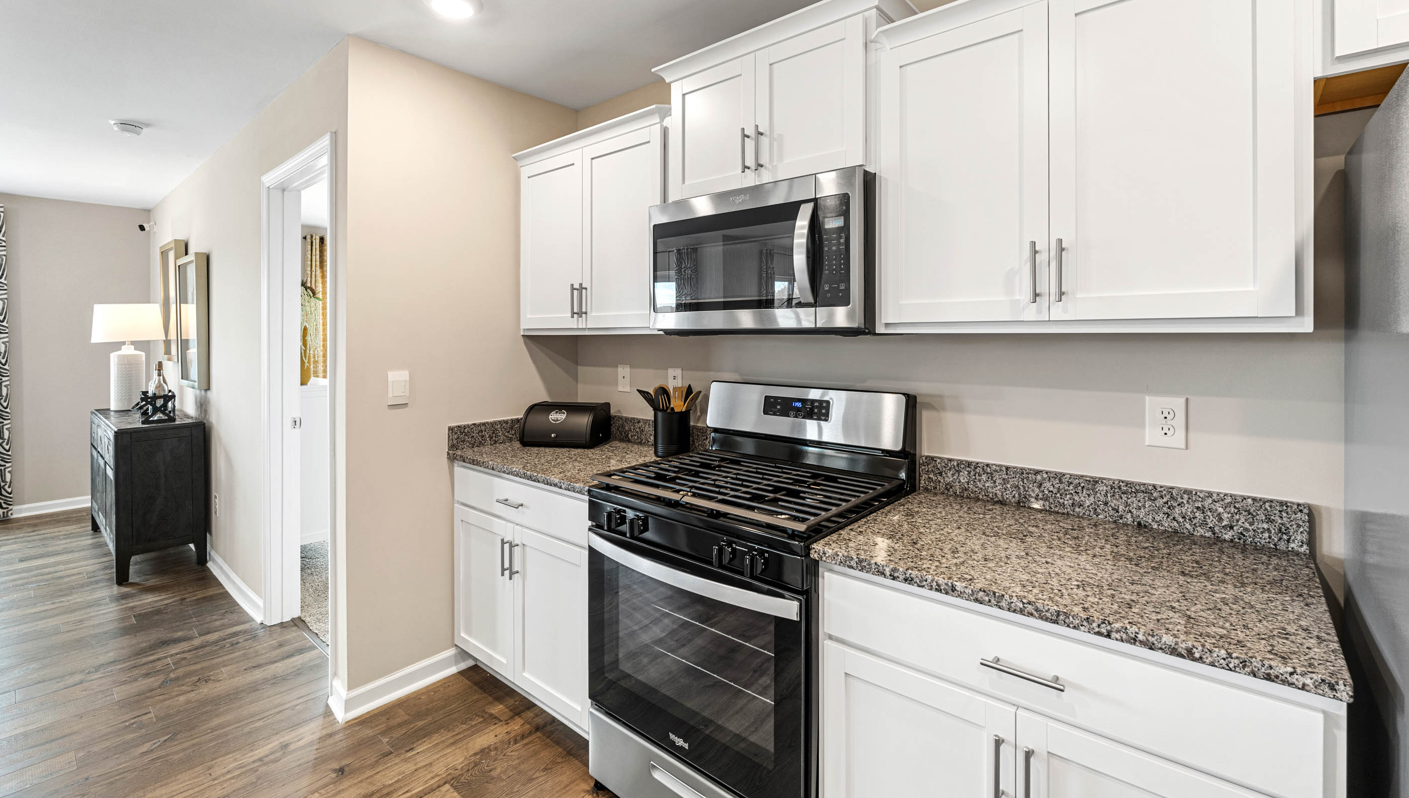 Kitchen and island with quartz countertops and stainless steel appliances.