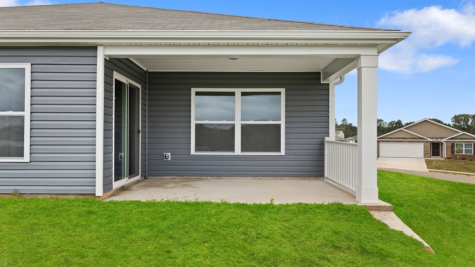 Back exterior of model home with covered patio.