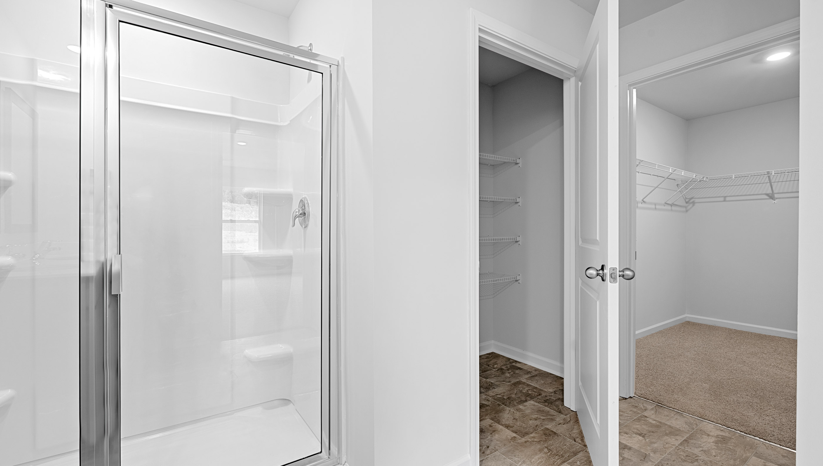 Bathroom with vanity and walk in shower.