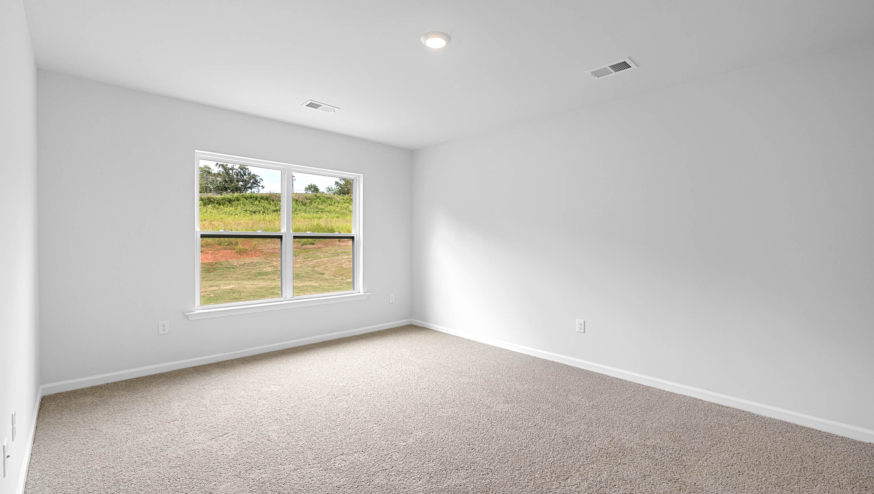Bedroom with carpet and window.