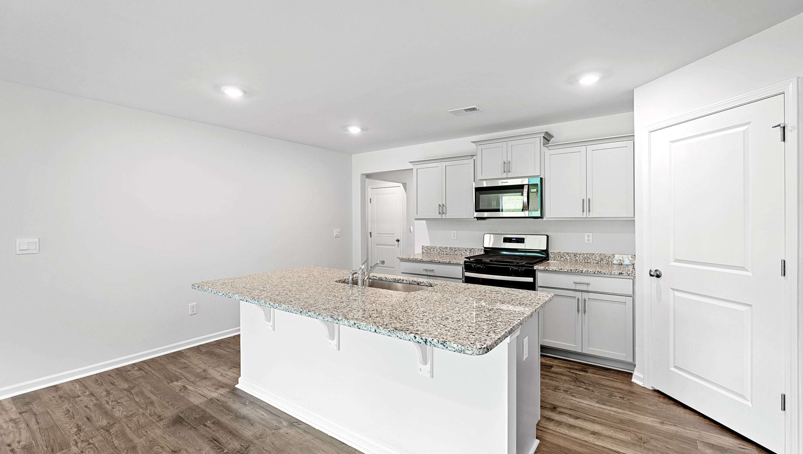 Kitchen with island and countertops.