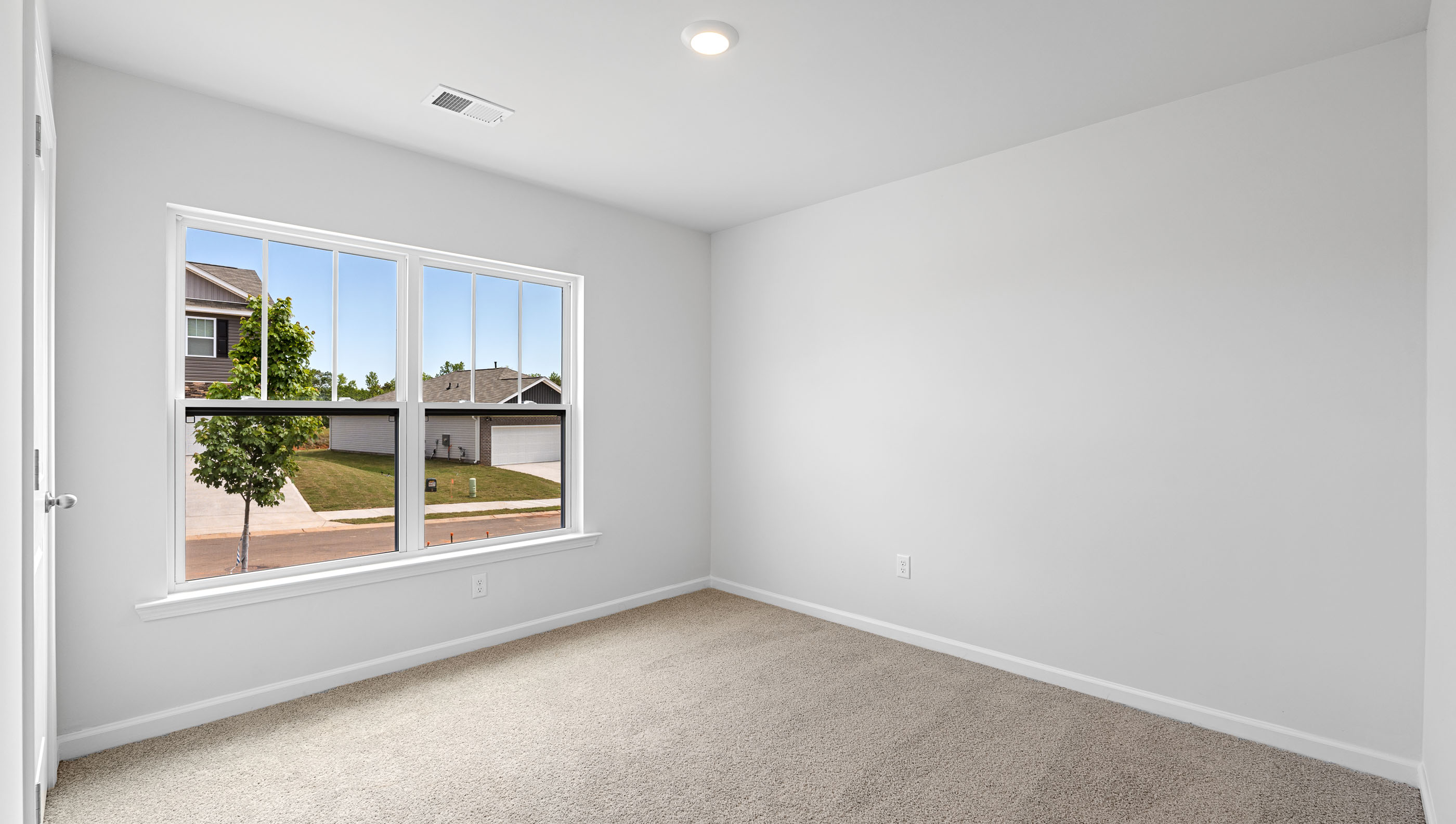 Bedroom with carpet and window.
