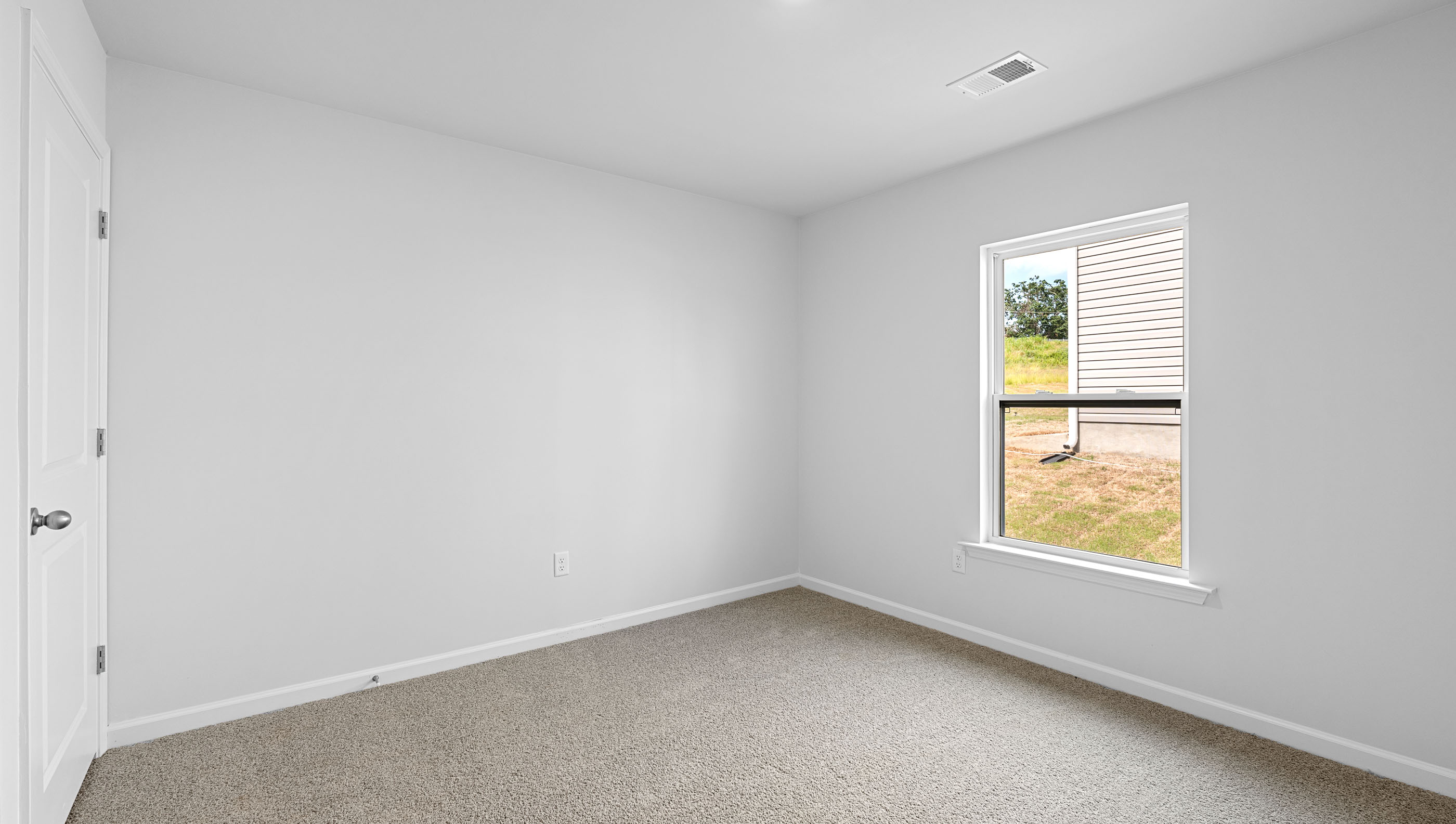 Bedroom with carpet and window.