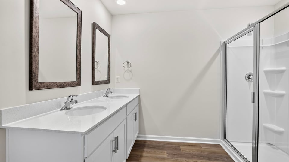 Bathroom with double vanity. and walk in shower.