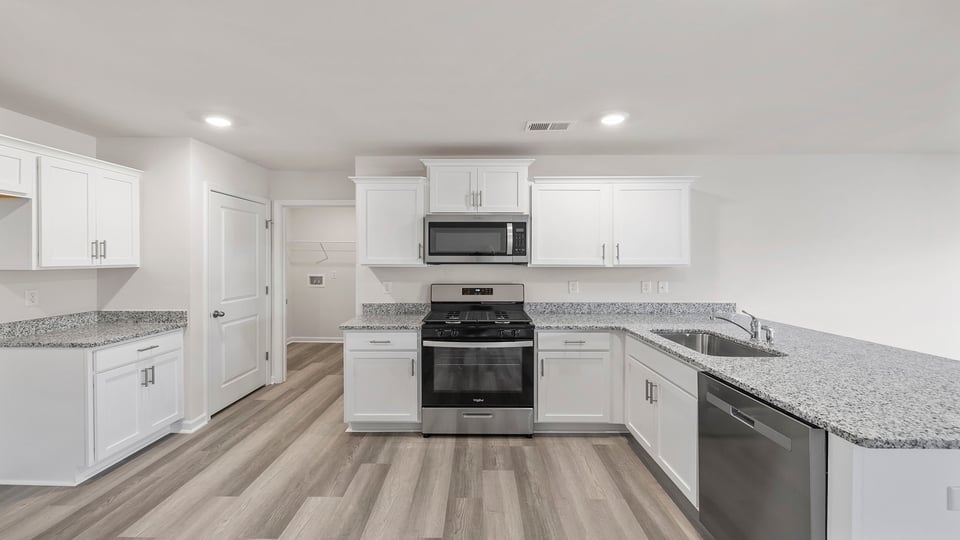 Kitchen and island with granite countertops.