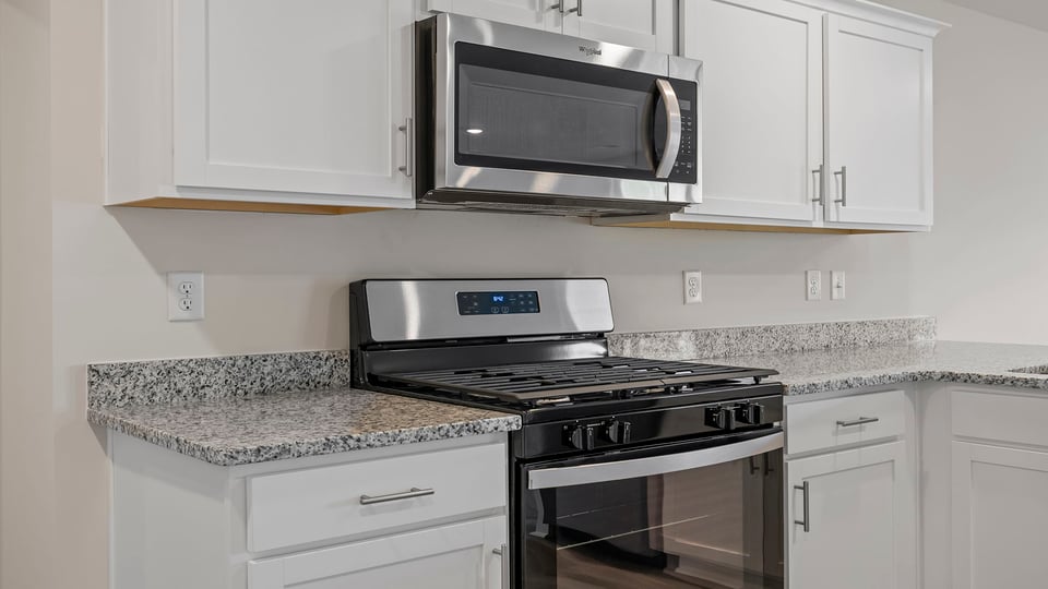 Kitchen with granite countertops and stainless steel appliances.