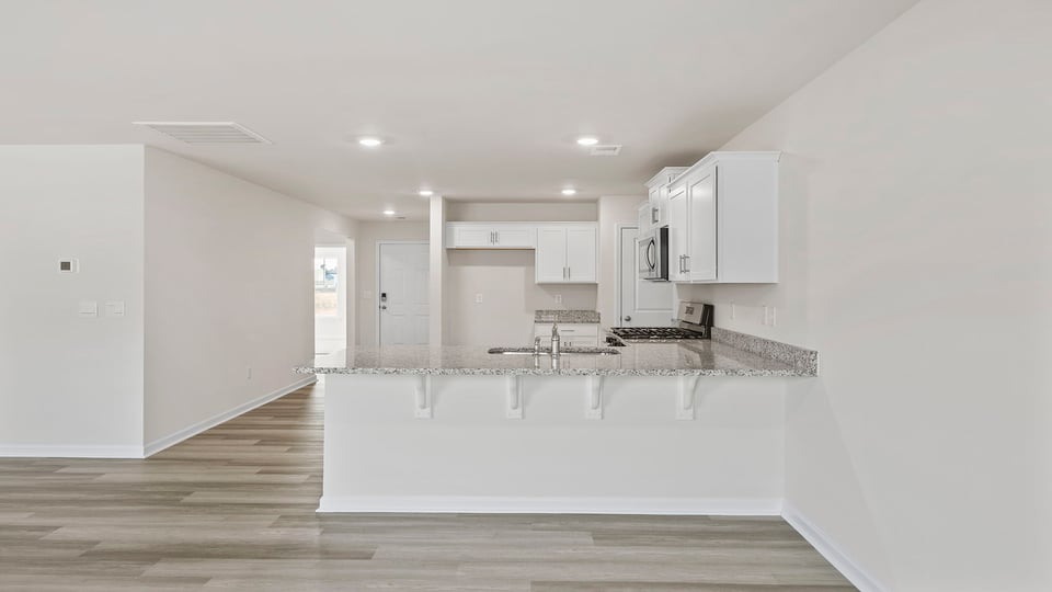 Kitchen and island with granite countertops.