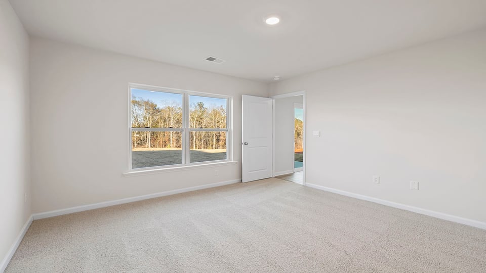 Bedroom with carpet and window.