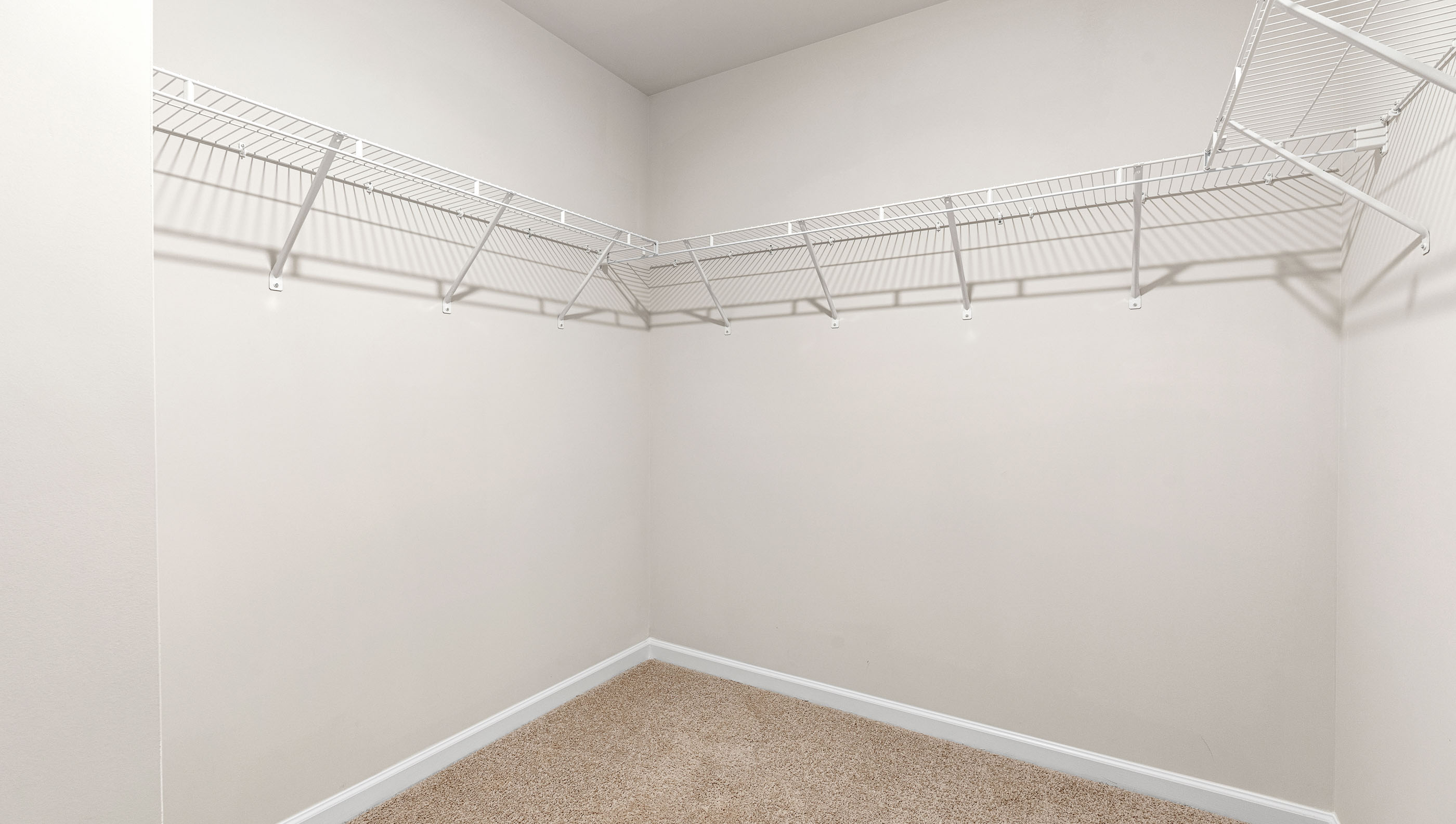 Walk in closet with shelves.