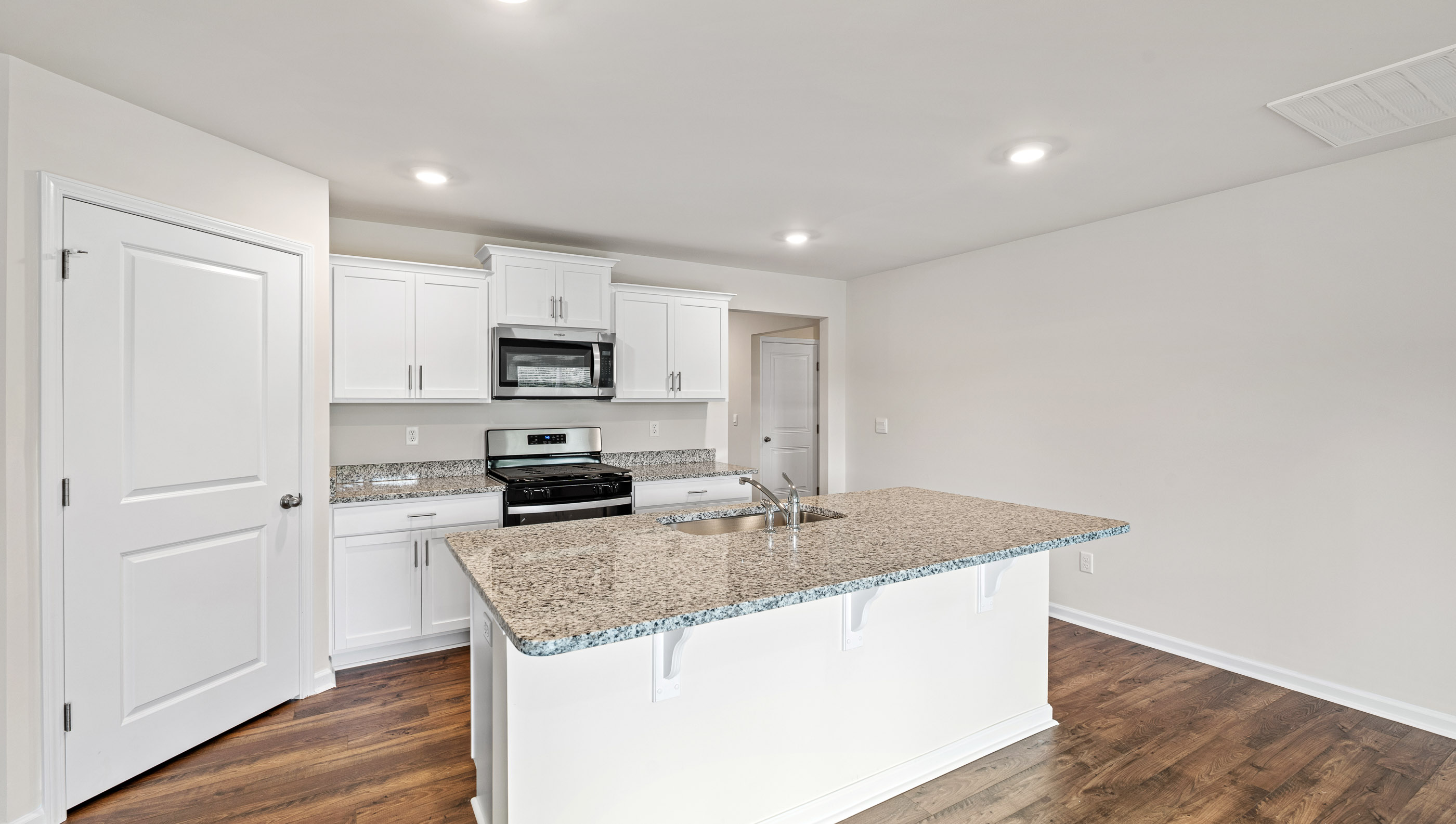 Kitchen and island with granite countertops.