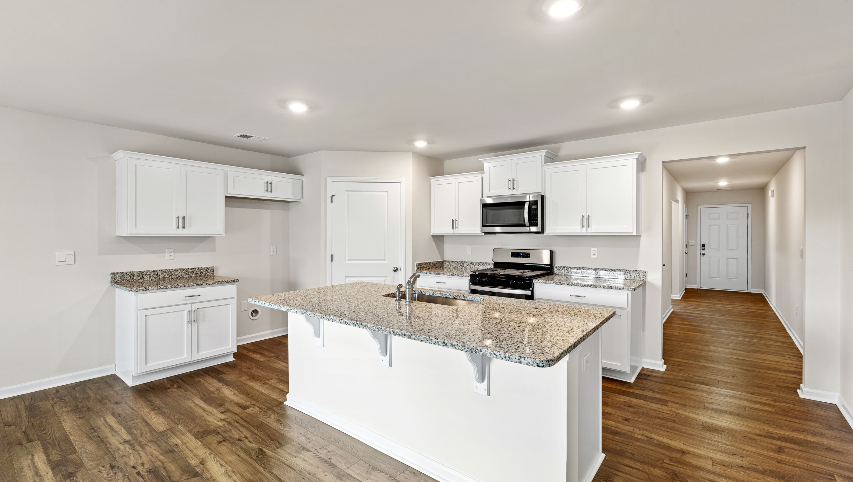 Kitchen and island with granite countertops.