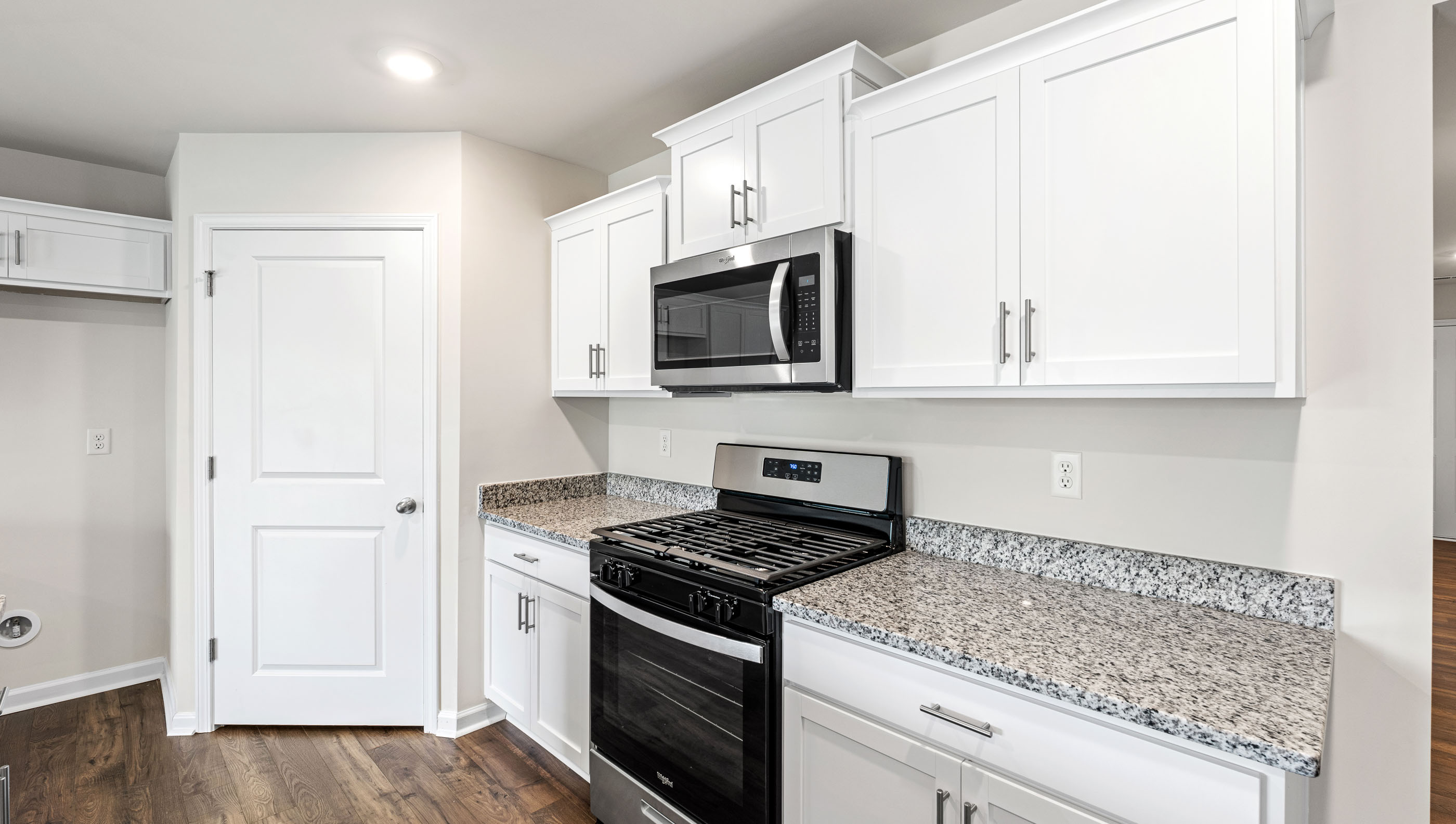 Kitchen with granite countertops and stainless steel appliances.