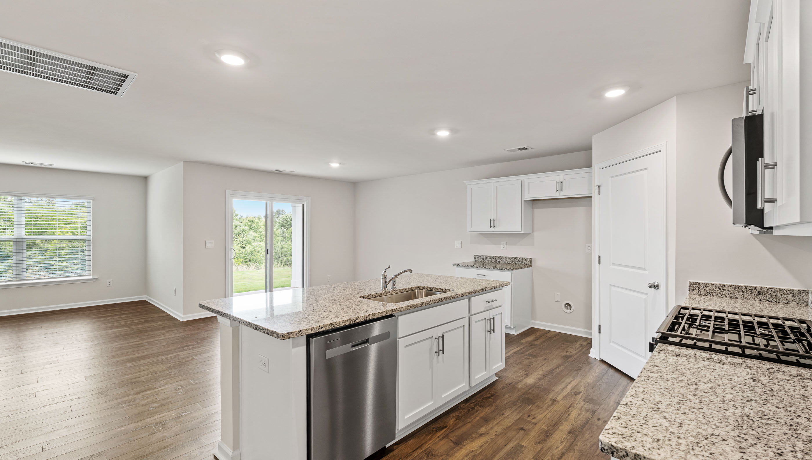 Kitchen and island with granite countertops.