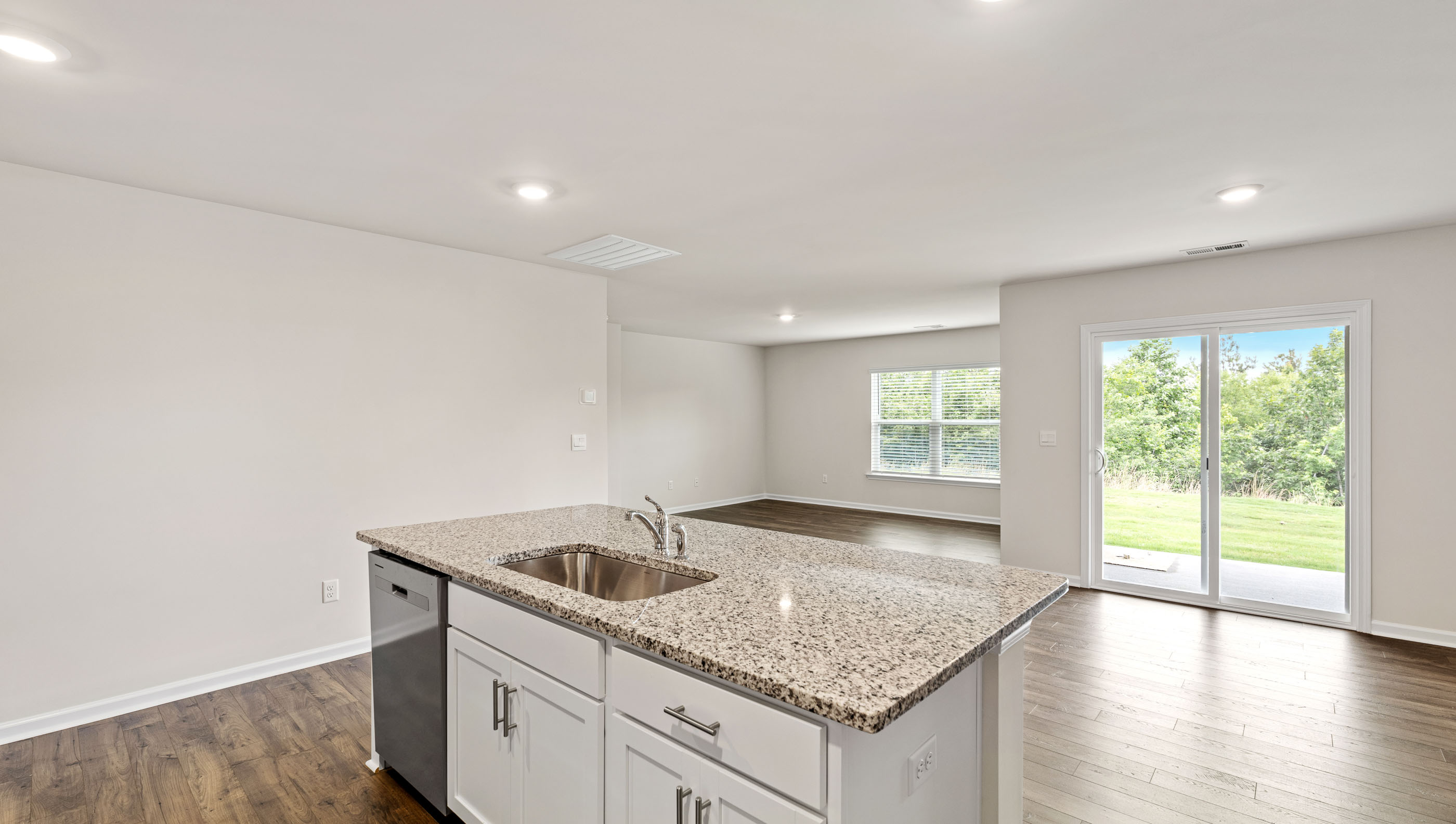 Kitchen and island with granite countertops.