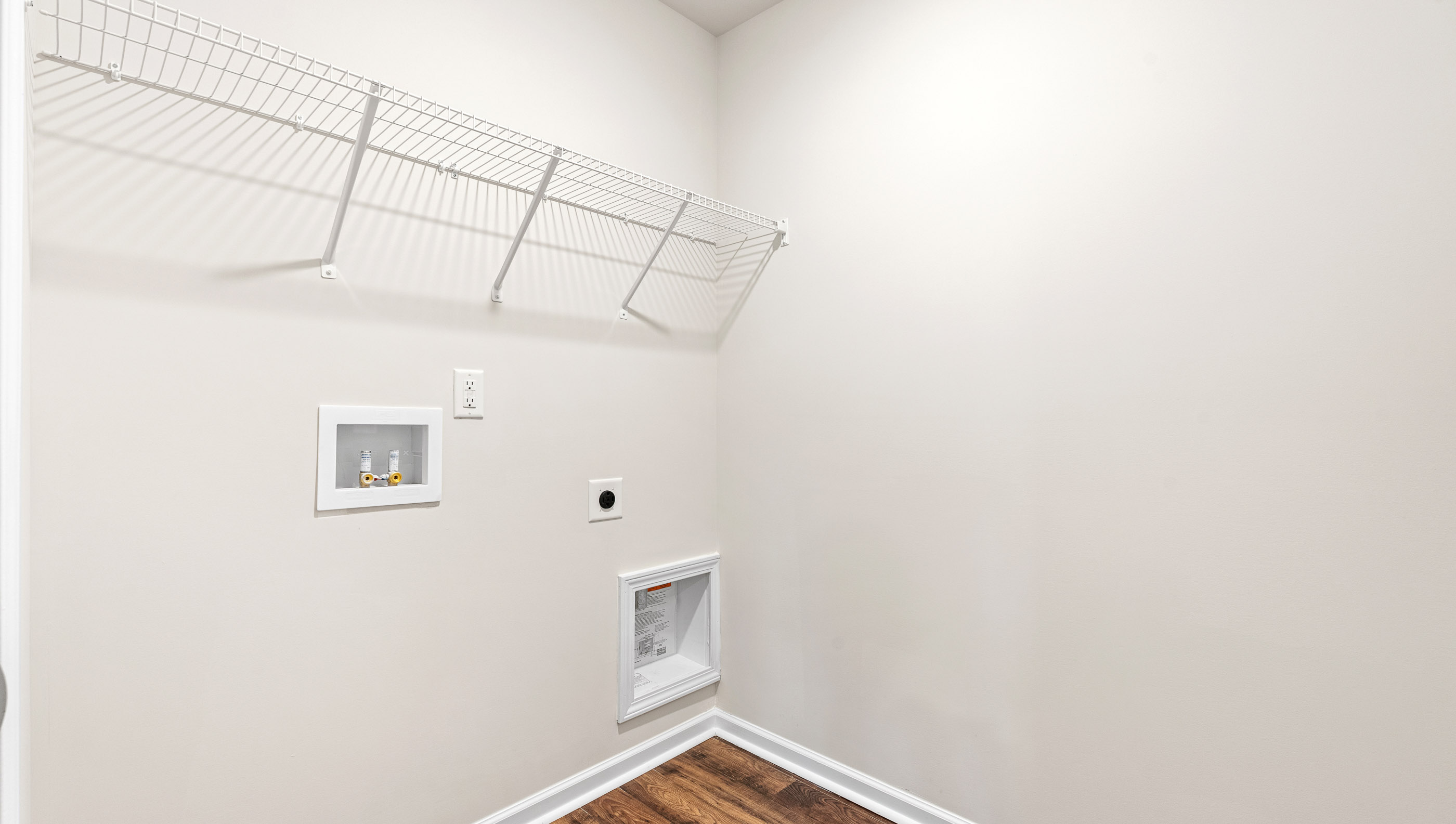 Walk in laundry with shelves.