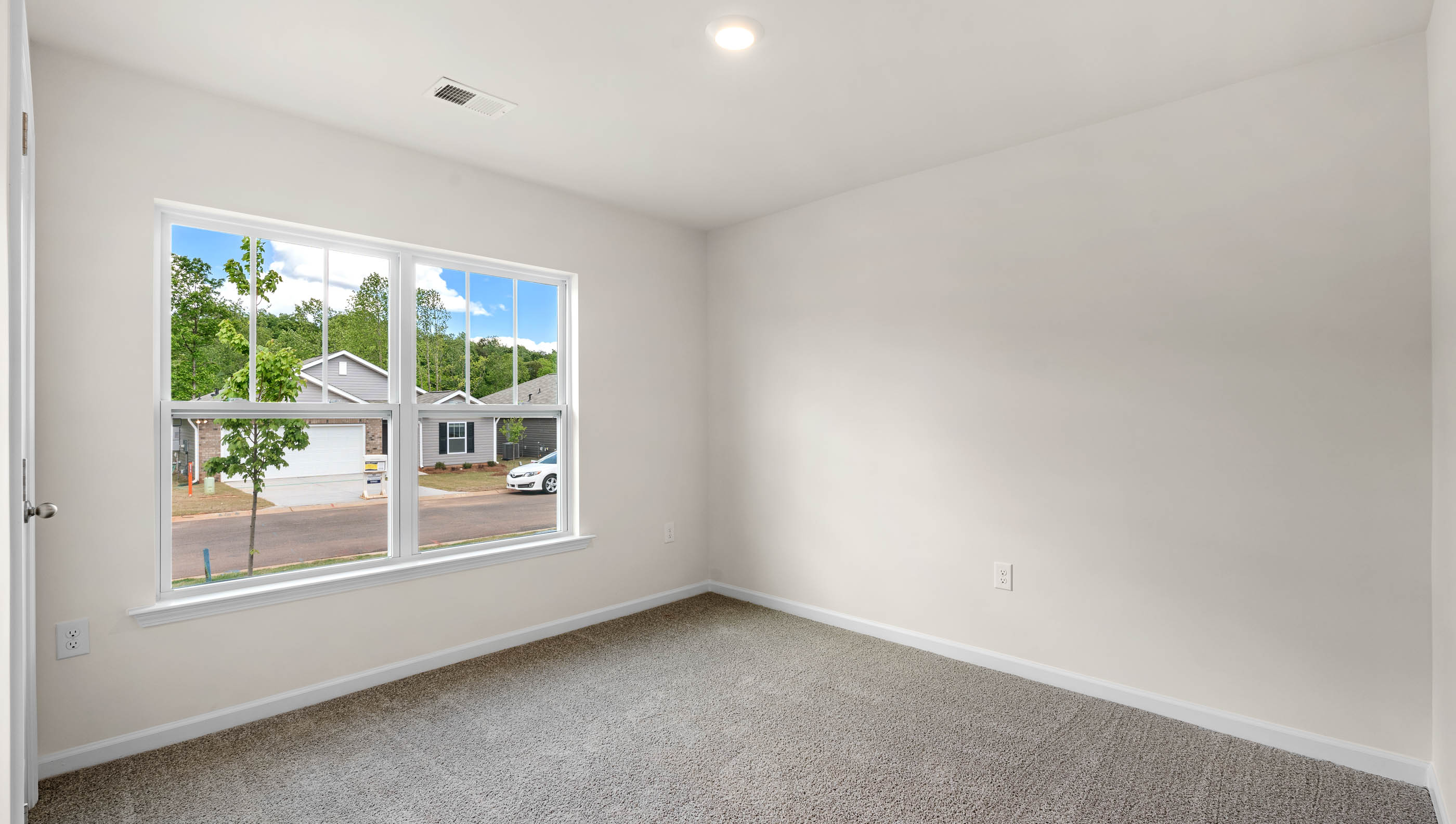 Bedroom with carpet and window.