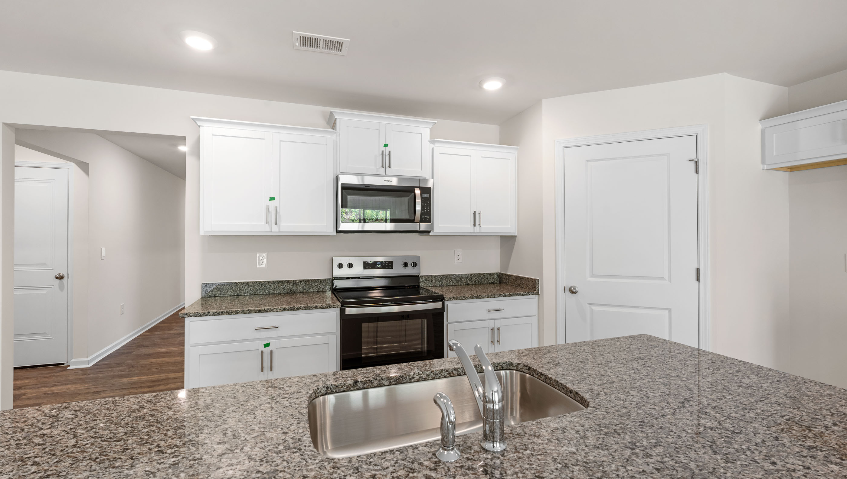 Kitchen and island with stainless steel appliances.