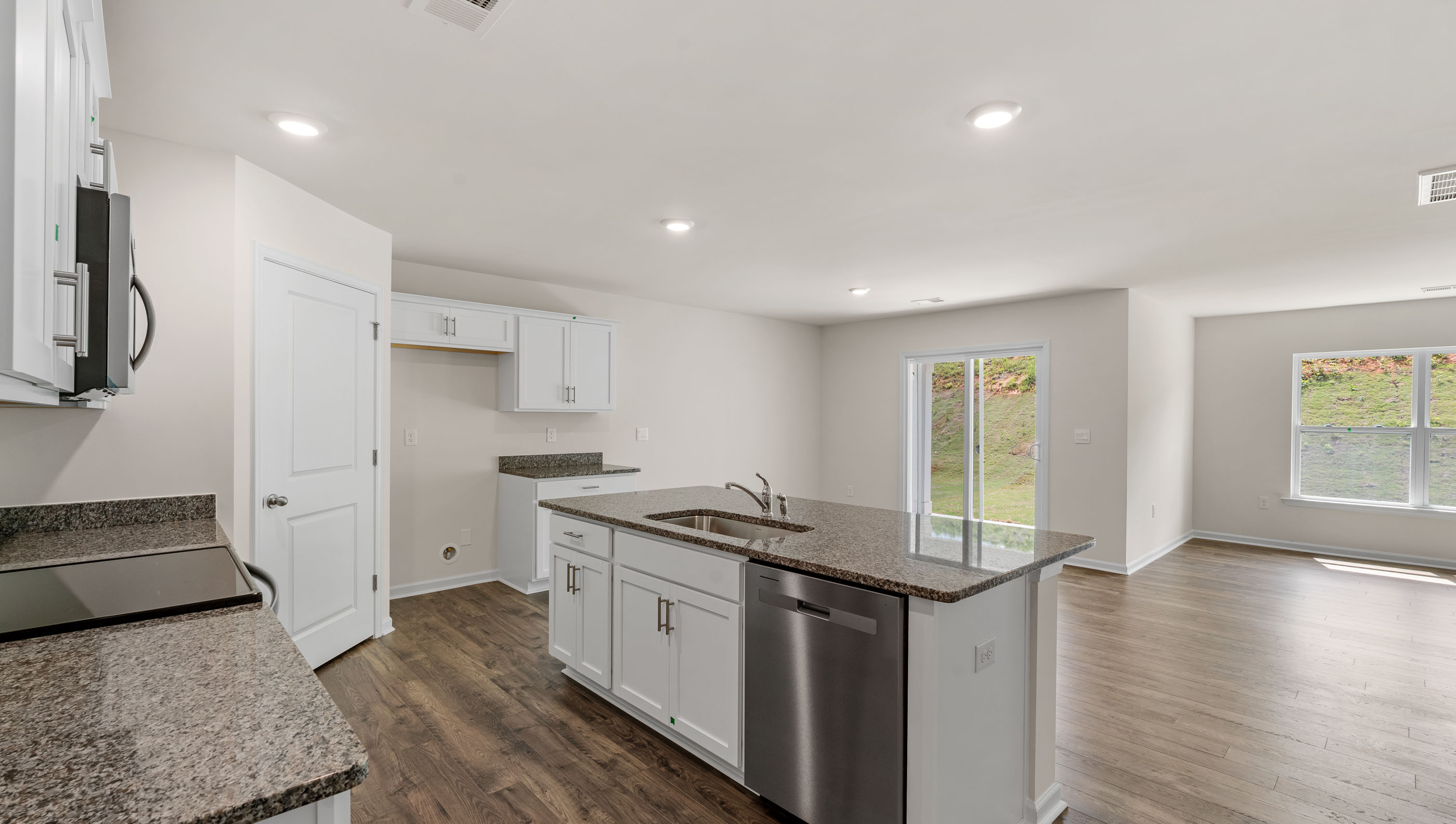 Kitchen and island with stainless steel appliances.