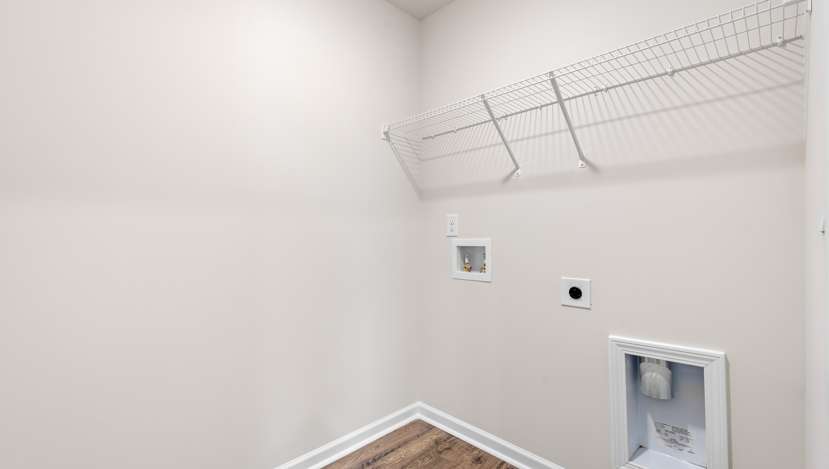 Walk in laundry with shelves.