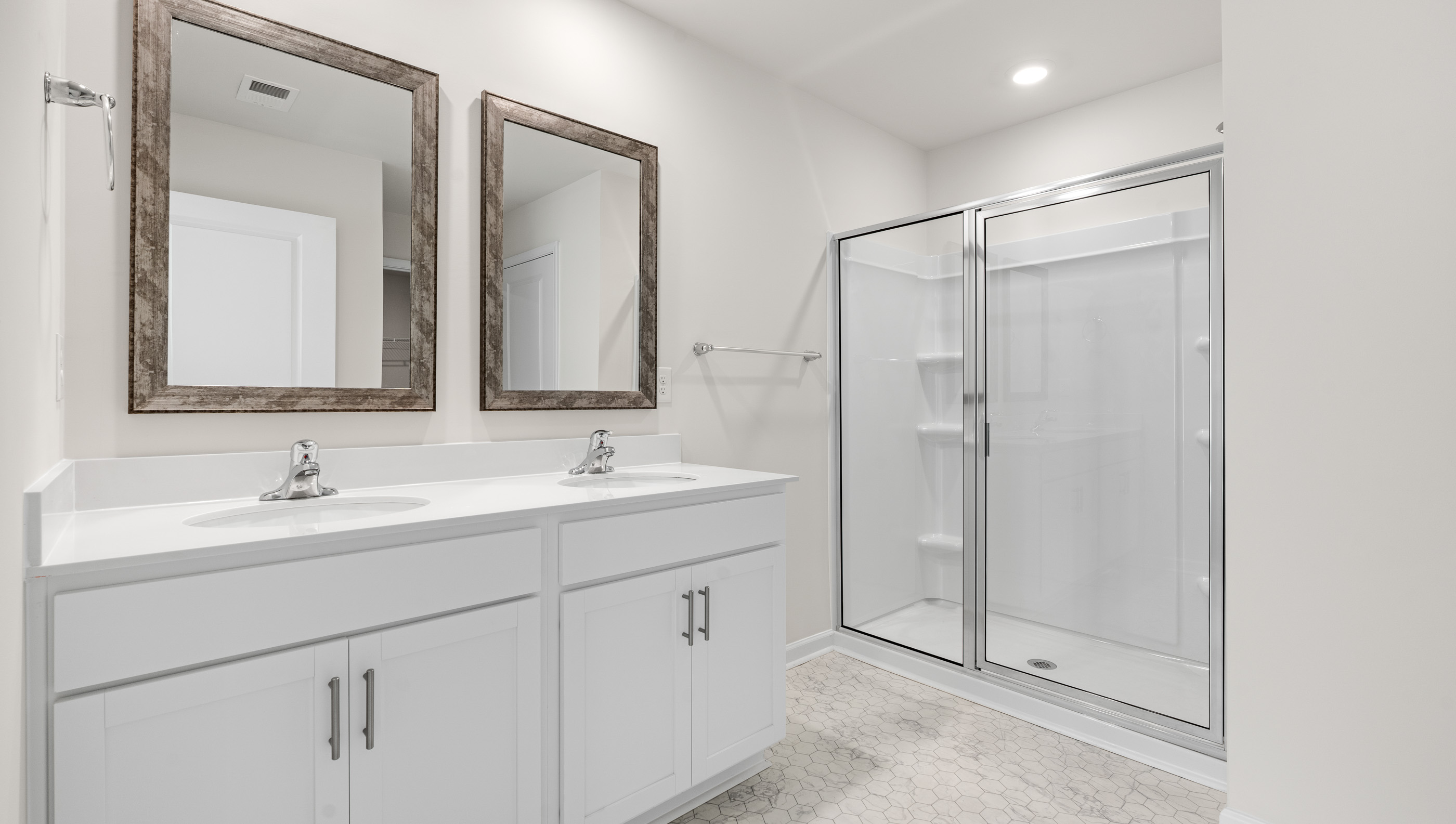 Bathroom with dual vanity and walk in shower.
