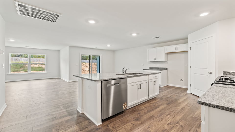 Kitchen with island and granite countertops.