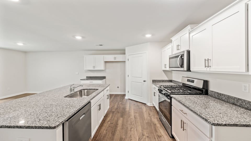 Kitchen with island and granite countertops.