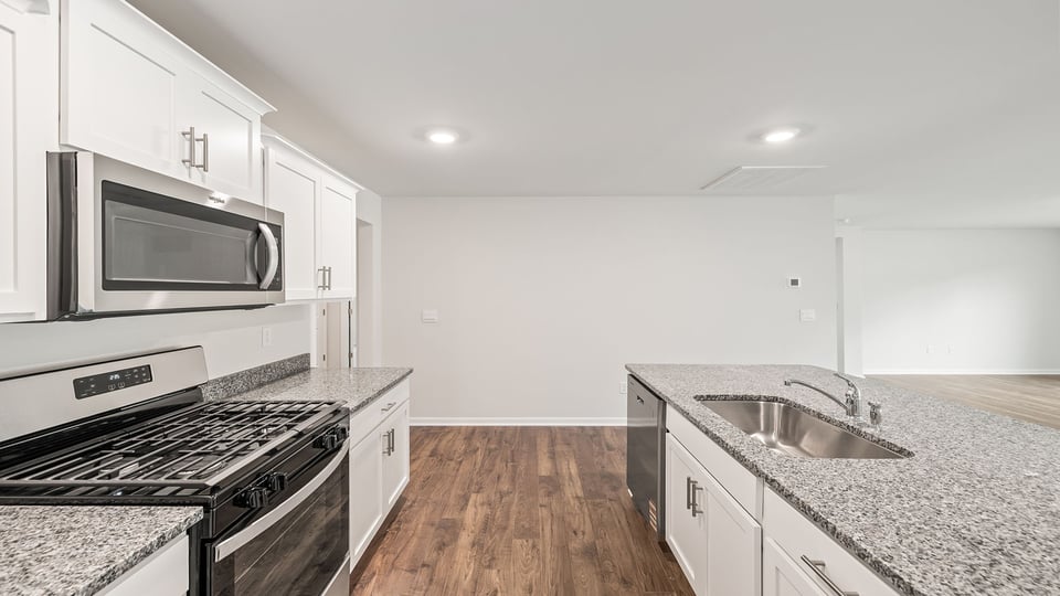 Kitchen with island and granite countertops.