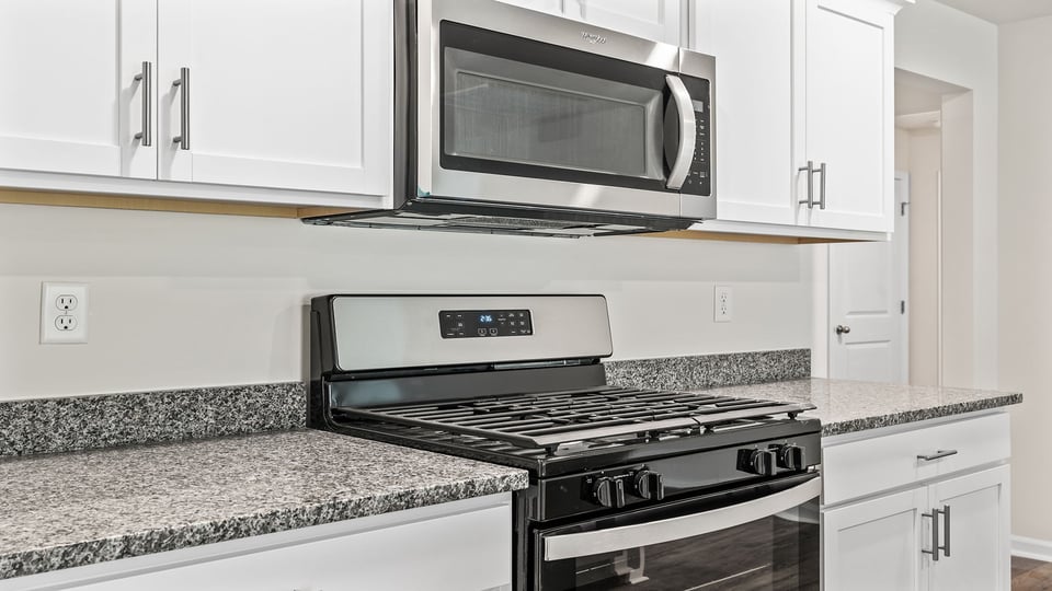 Kitchen with granite countertops and stainless steel appliances.
