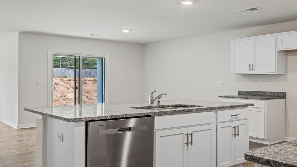 Kitchen with island and granite countertops.