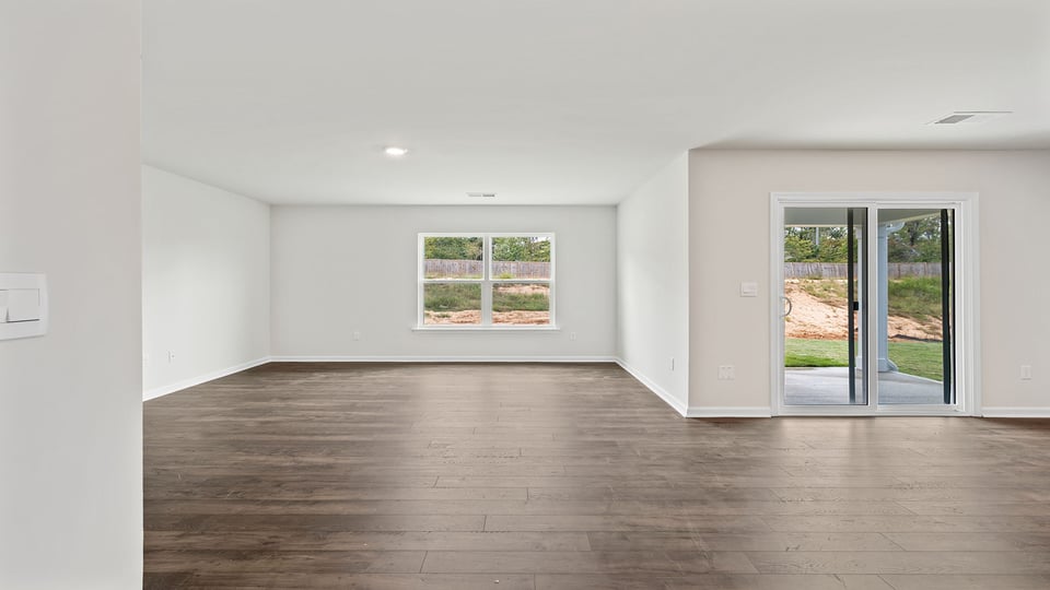 Family room with with window and sliding door.