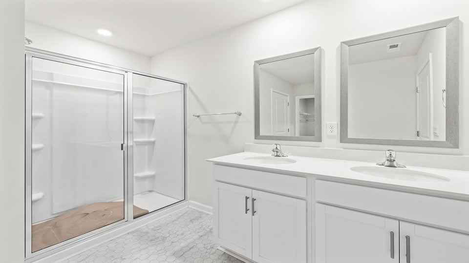 Bathroom with vanity and walk in shower.