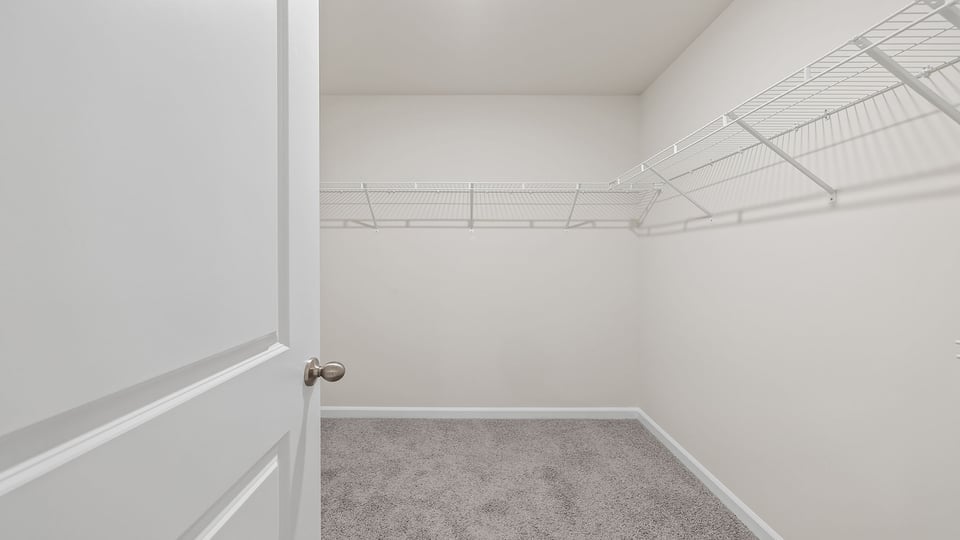 Walk in closet with shelves.