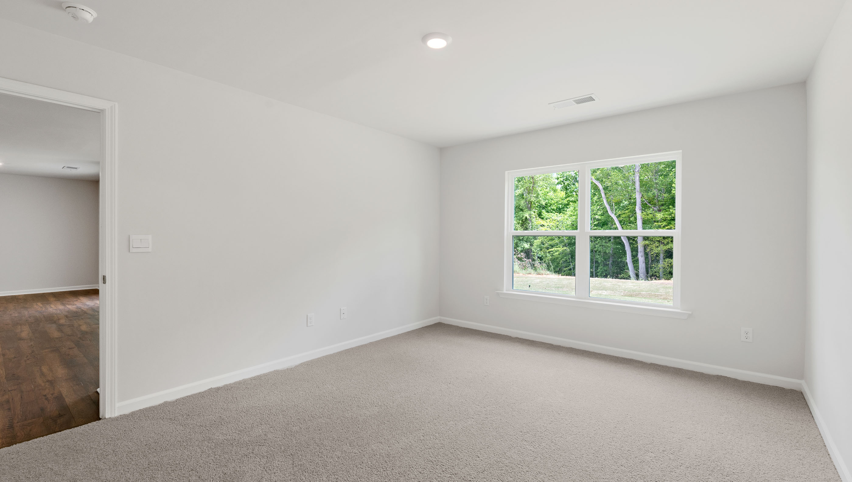Bedroom with carpet and window.