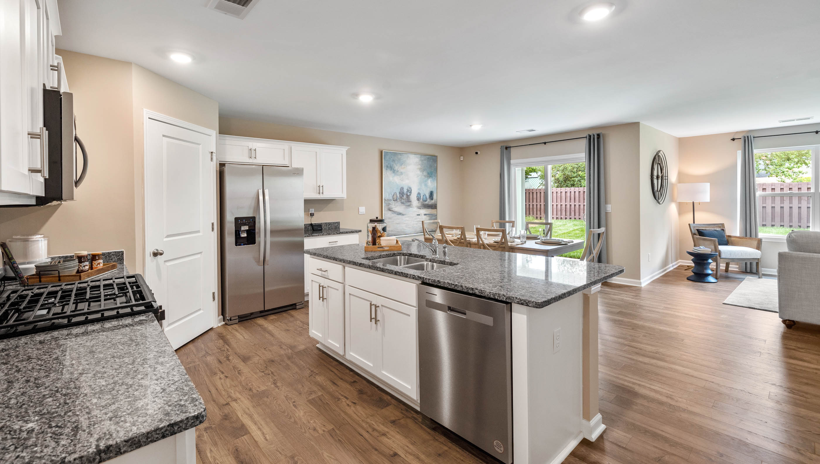 Kitchen and island with granite counter tops.