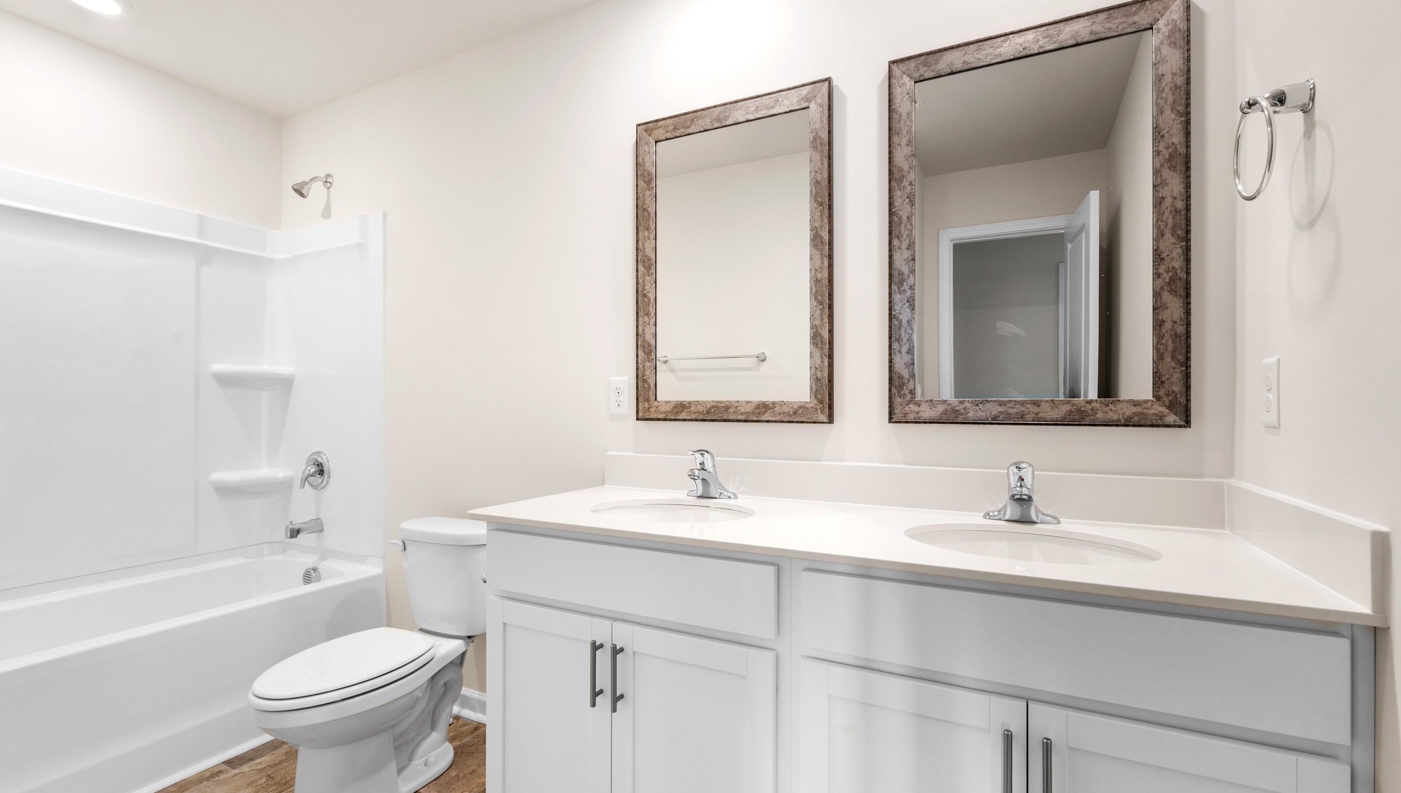 Bathroom with double vanity sink and tub.