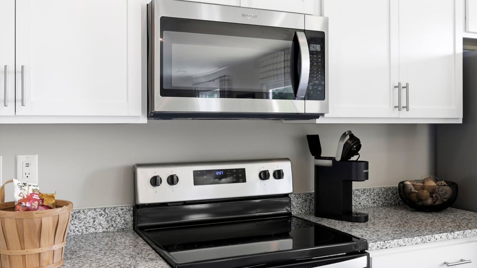Kitchen and island with stainless steel appliances.