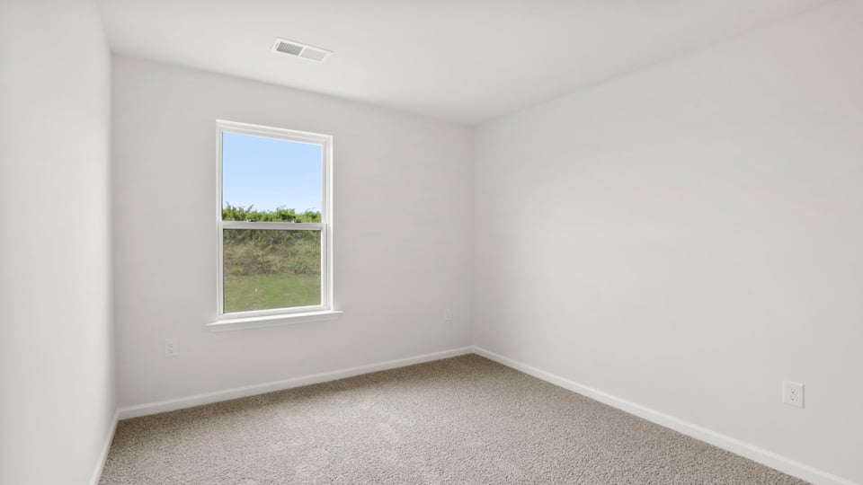 Bedroom with carpet and window.