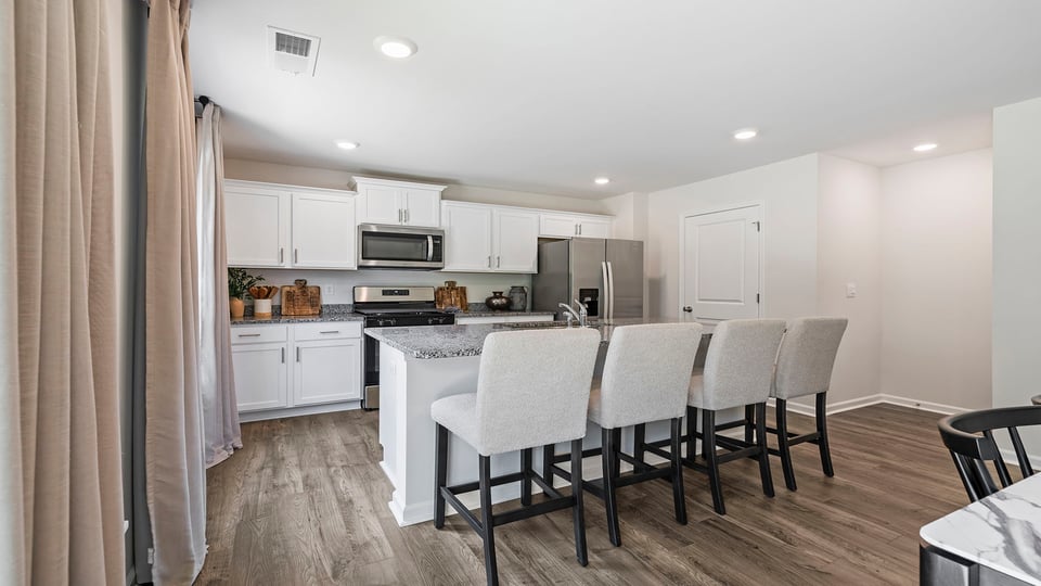 Kitchen and island with quartz countertops.